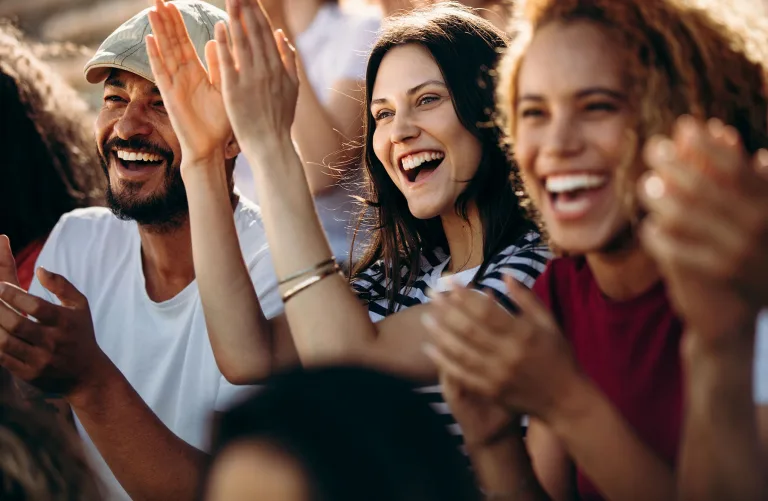 A crowd of people clapping